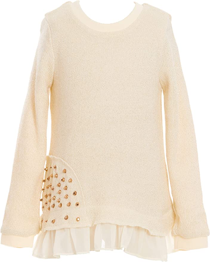 Little Girl’s Thin Knit Gold Stud Ruffle Pullover  Round Neckline   Long Sleeves   Thin Knit Material   Faux Layered Ruffle Hem Look  Gold Embellishments on Side  SELF: 88% Acrylic / 12% Lurex, CONTRAST: 100% Polyester, LINING: 100% Polyester  Made in high quality sweater knit fabrication with gold metallic thread.