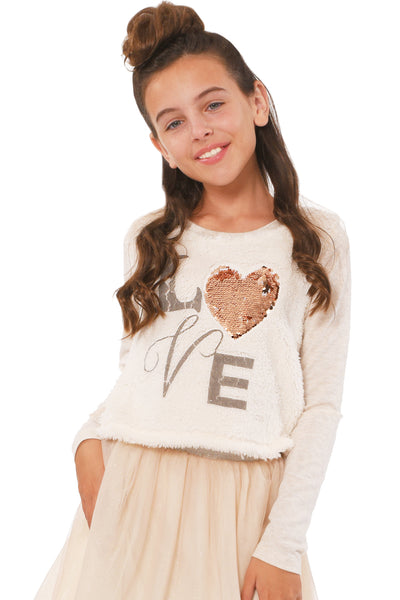 Truly Me Girls LOVE Graphic High-Low Top Simple, round neck line Long sleeves A flattering high-low silhouette with fabric blocking Made of a high quality faux fur and heather knit Front bodice includes the faux fur and LOVE graphic LOVE graphic made with a gold sequin heart  Imported